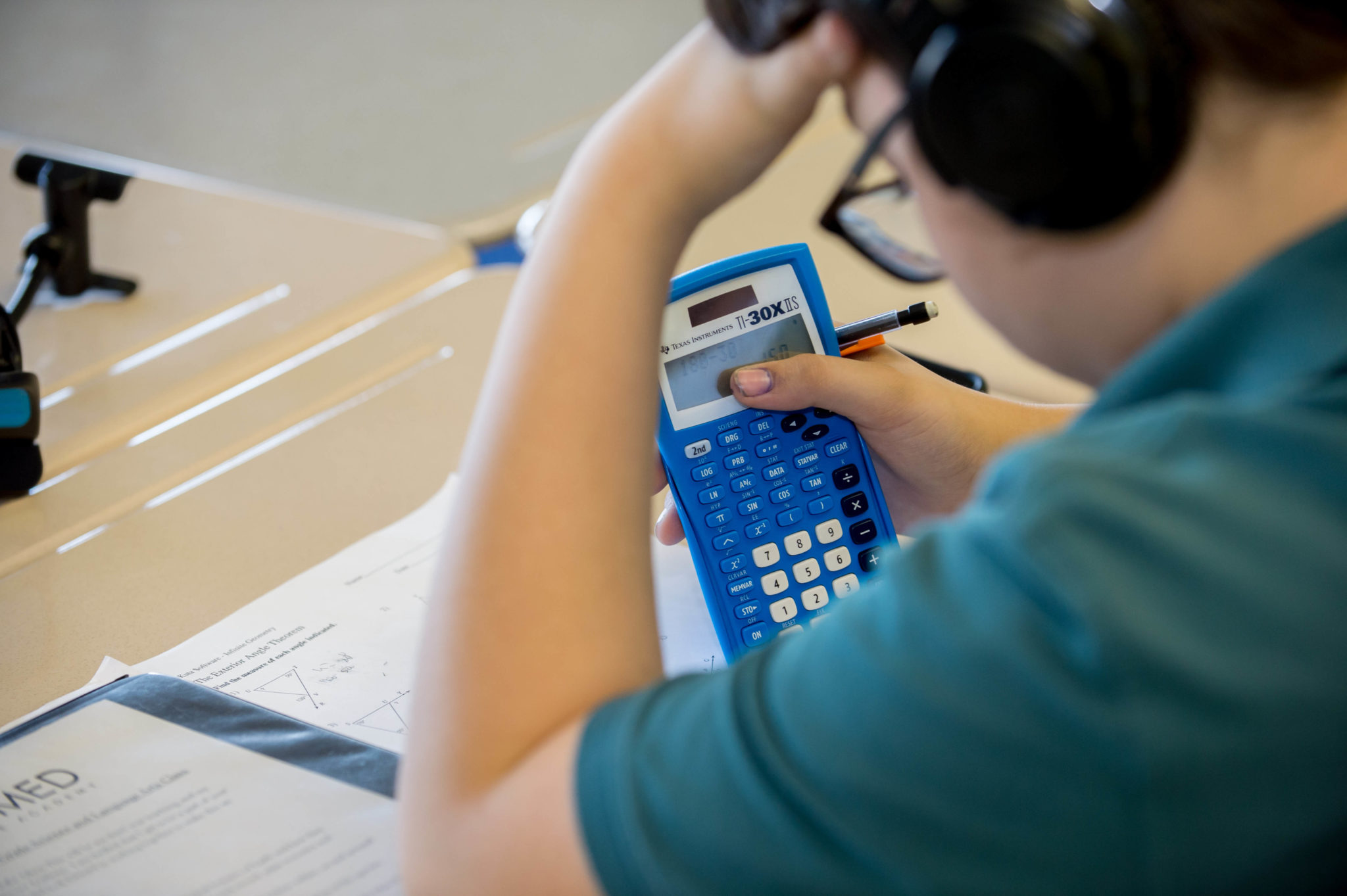 Male student using calculator