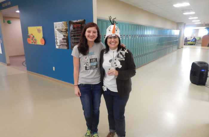 Student poses with instructor wearing and Olaf costume